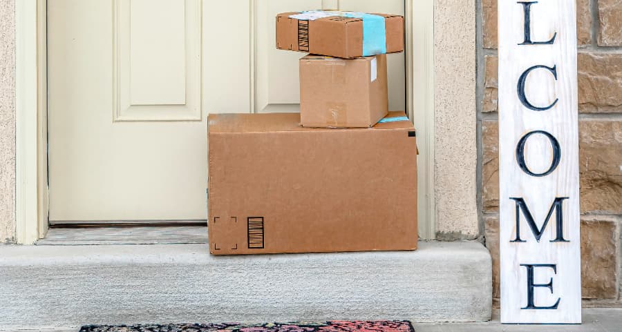 Packages on the doorstep of a home with a welcome sign in Gainesville